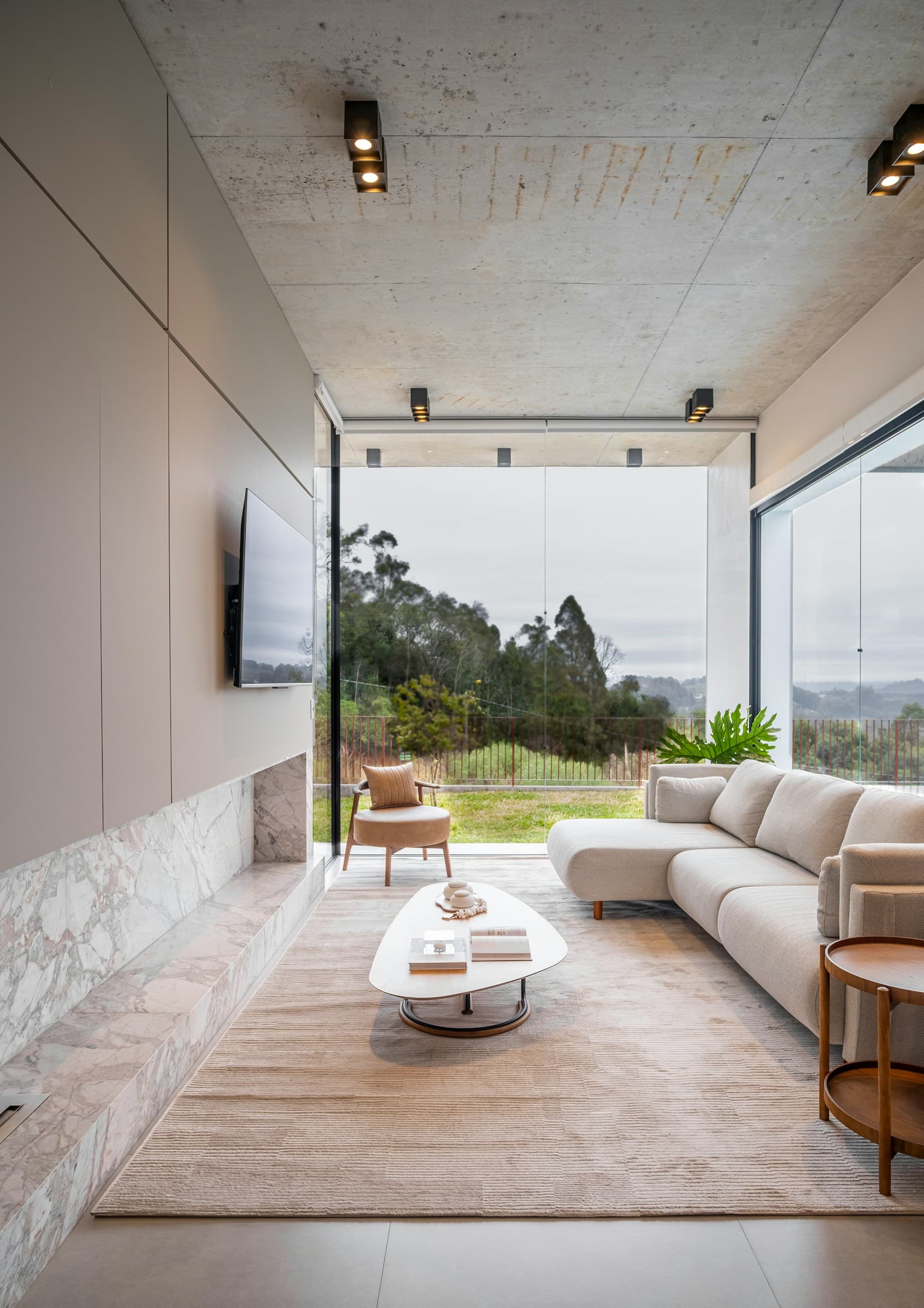 Bright living room with a glass wall opening to the garden