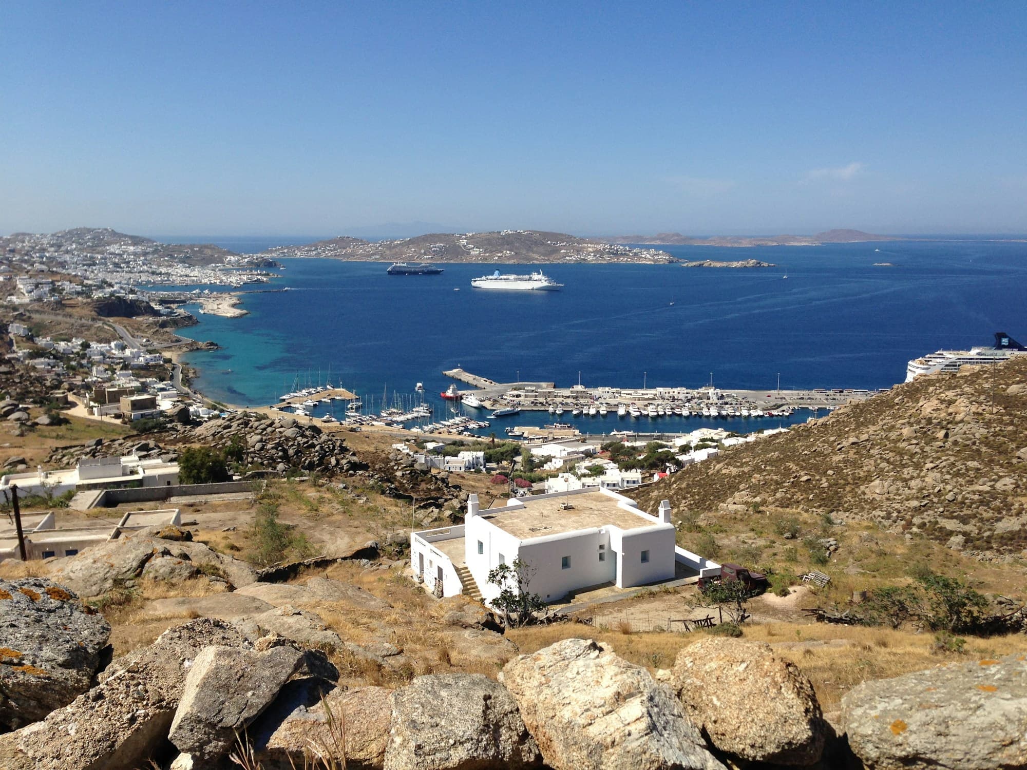 White house on a rocky hillside above a bay