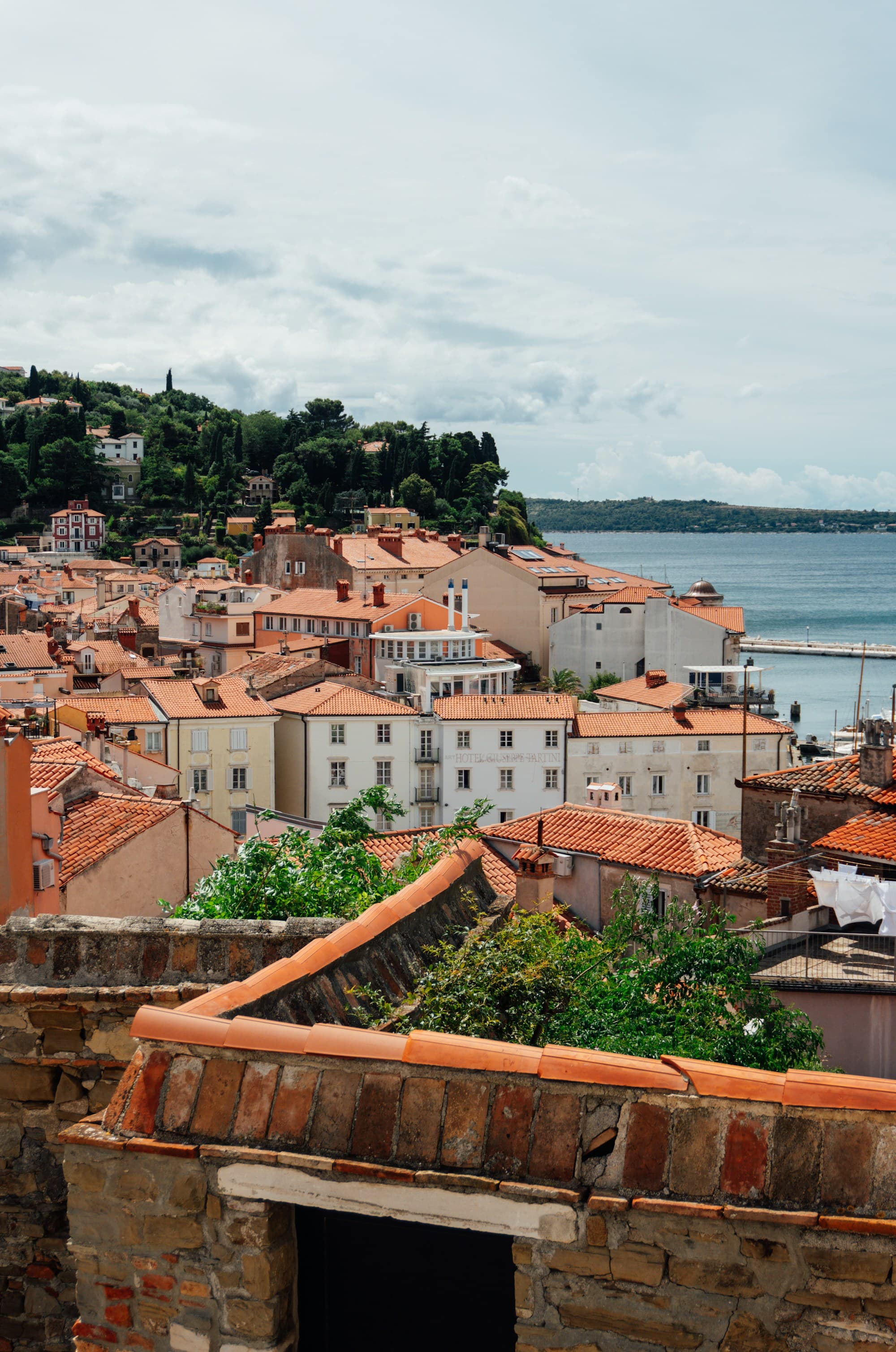 Old-town rooftops with the sea beyond